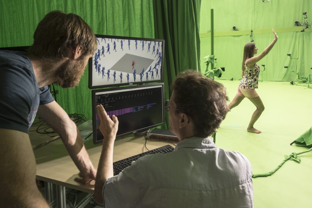 Engineers monitoring real time reconstruction, while dancer is showing on the stage